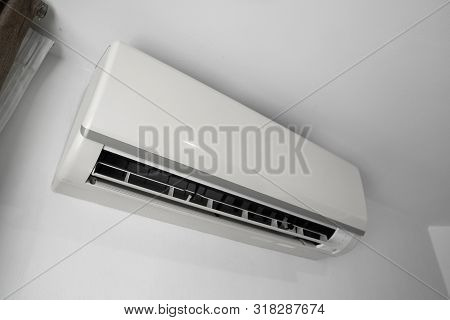 Air Conditioner Mounted On A White Wall In The Living Room Or Bedroom. Indooor Comfort Temperature. 