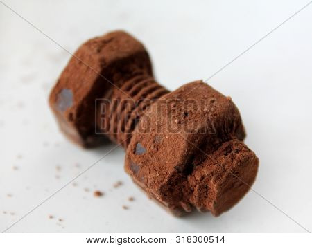 Rusty Bolt And Nut Made Of Chocolate Isolated On White Background. Chocolate Chip Scattered On Smoot