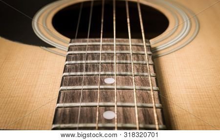 Fingerboard And Inlay And Old Acoustic Guitar String With Sound Hole And Pickguard