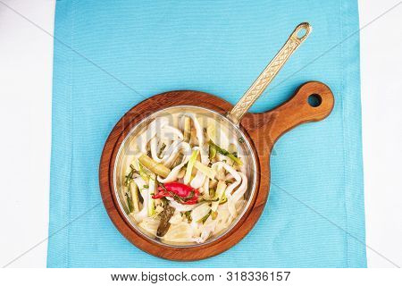 Mediterranean Noodle Soup With Colmar Rings, Onions, Cucumbers And Hot Peppers