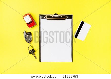 Paper Blank With Toy Red Car, Creadit Card And Keys On A Yellow Background. Technical Inspection Or 