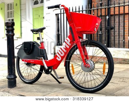 LONDON, UK - AUGUST 21, 2019: A Jump dockless electric bicycle parked on the pavement in a street in North London, UK.