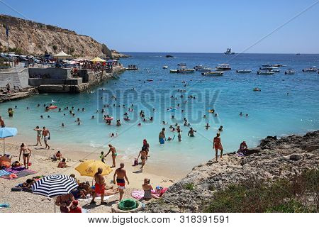 Qala, Malta - August 17, 2019: Many Unidentified People On  The Beach Of Hondoq Bay. Island Of Gozo.