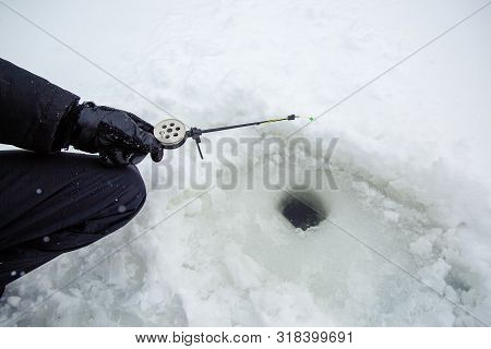 Close Up Of A Ricky Fisherman With A Fishing Rod. Ice And Fishing Rod For Winter Fishing. Winter Fis
