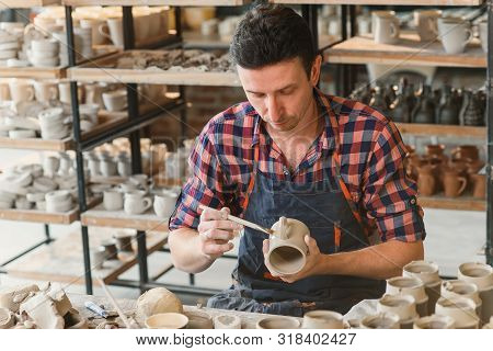 Talanted Caucasian Man Making Decoration For Cup.