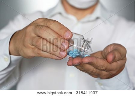 Doctor Giving Pills, Physician In Medical Mask Holding In Hands Medication In Capsules. Concept Of D