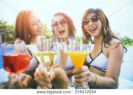 Three Younger Asian Woman Happiness Drinking Beverage In Waer Swimming Pool