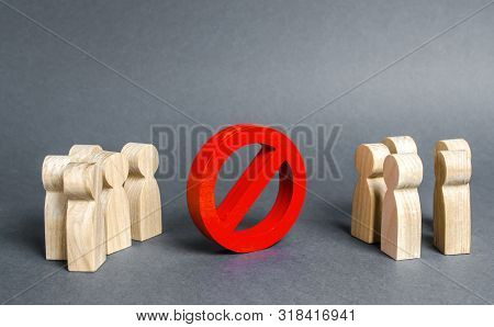 Two Groups Of People Are Divided By A Red Prohibition Sign No. Prohibition, Taboo, And Rejection. Co