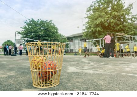 The Takraws In The Plastic Basket On The Cement Floor Beside The Field Is Used For Students To Pract