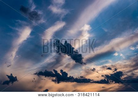 Evening Sky At Sunset Background. Dark Clouds Hanging Above Horizon. Majestic Cloudscape In Blue, Or