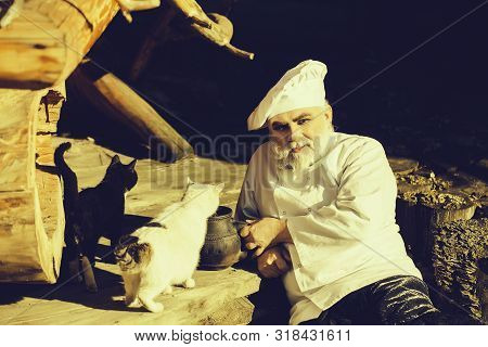 Bearded Man Cook Chef In Uniform And Hat With Long Beard On Smiling Face Holding Iron Old Tea Kettle