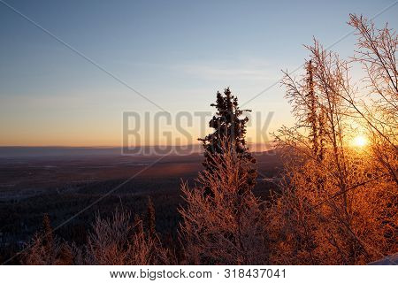 Snowboarder Ride On The Top Of Snowy Hill In Ski Resort During Calm Winter Sunset. Scenery Of Athlet