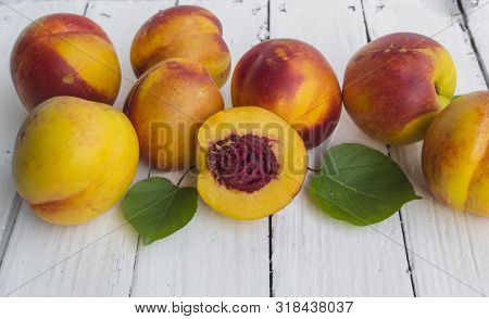 Delicious And Juicy Peach (nectarina) On White Wooden Table With Place For Text.
