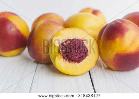 Delicious And Juicy Peach (nectarina) On White Wooden Table With Place For Text.