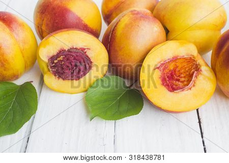 Delicious And Juicy Peach (nectarina) On White Wooden Table With Place For Text.