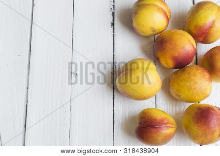 Delicious And Juicy Peach (nectarina) On White Wooden Table With Place For Text.