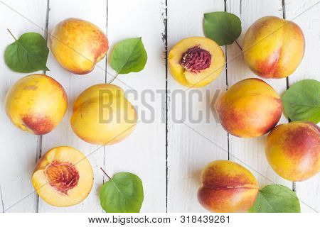 Delicious And Juicy Peach (nectarina) On White Wooden Table With Place For Text.
