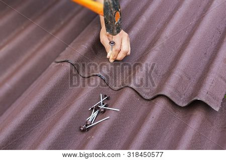 Roofer Installs Asphalt Shingles Ondulin, Roof Repair.