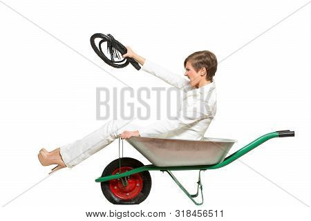 Production Control Management Concept. Business Woman Sits In A Wheelbarrow And Points Her Hand Forw