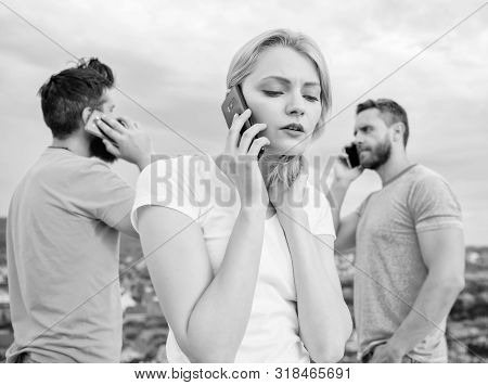 Using The Mobile Technology While On The Move. Group Of Friends Talk On Cell Phones. Modern People W