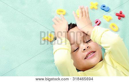 Little Boy At Preschool Learning Numbers Playing With Various Toy Numbers And Shapes Stock Image And