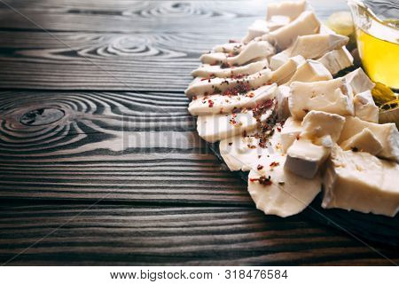 Assortment of cheeses, and fruit on a wooden table. Top view. Free space for text.