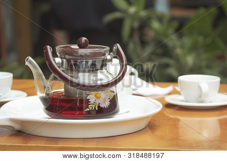 Tea Cups And Tea Pot. Traditional Green Tea In A Kettle On The Table