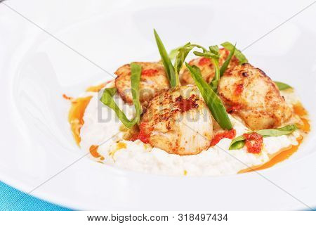 Mediterranean Fish On A Mashed Potato Pillow With Tomato Sauce