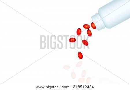 Pour Red Soft Gel Capsule Pills Out Of Drug Bottle Isolated On White Background. Red Soft Gelatin Ca