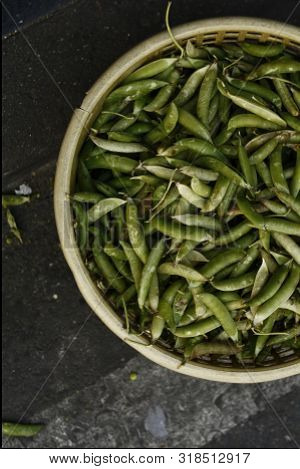 Basket Of Fresh Green Beans Or Peas On A City Street Market In Southeast Asia