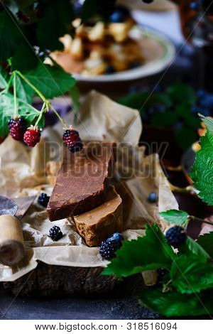 Norwegian Cheese Brunost On The Cutting Board .style Rustic.selective Focus
