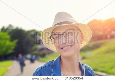 Happy Young Caucasian Bald Woman In Hat And Casual Clothes Enjoying Life After Surviving Breast Canc
