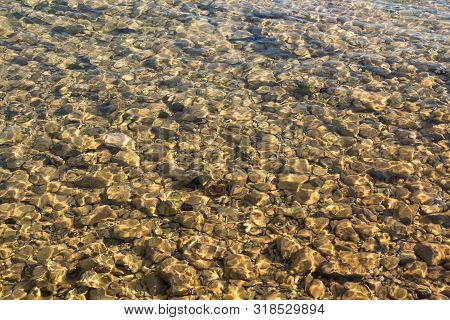 Small Pebbles In A Shallow Clean And Clear Water Of The Adriatic Sea. Tisno, Croatia.