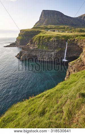 Waterfall And Cliffs On Vagar. Faroe Islands Dramatic Coastline. Gasaladur