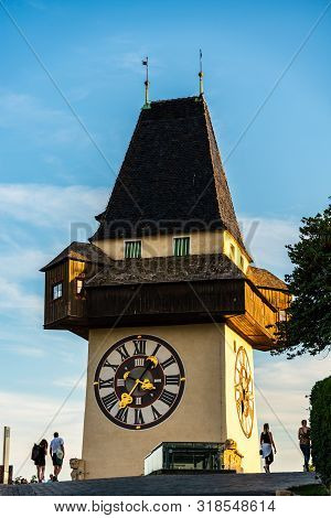 Graz, Austria - 17.08.2019 : View At Famous Clock Tower Uhrturm At Schlossberg Hill. Tourists Walkin