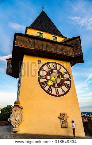 Graz, Austria - 17.08.2019 : View At Famous Clock Tower Uhrturm At Schlossberg Hill. Girl With Phone