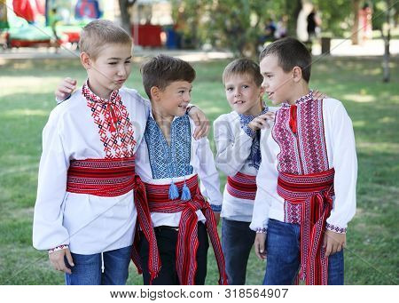 Ukraine, Pokrov - August 23, 2019: National Flag Day Celebration. Four Boys Friends Dressed In Folk 
