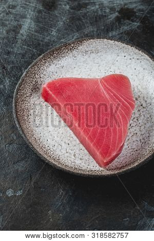 Raw Fresh Tuna Stek On Gray Plate. Black Background