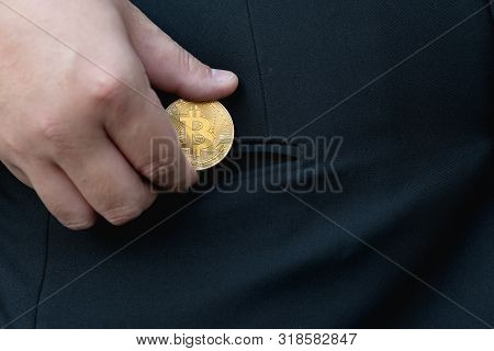 Golden Bitcoin In A Man Hand, Digitall Symbol Of A New Virtual Currency.