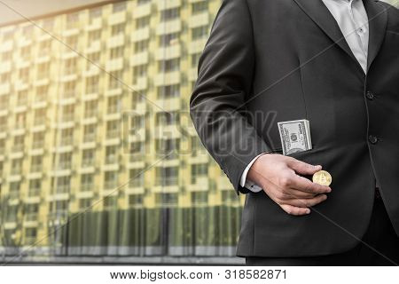 Golden Bitcoin In A Man Hand, Digitall Symbol Of A New Virtual Currency.