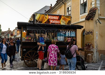 Brasov, Romania - 2019. Tourists Waiting In Line To Buy Kurtos Kolacs.