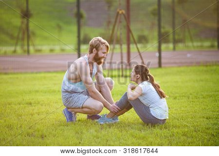 Sit Ups Fitness Couple Exercising Sit Up Outside In Grass. Fit People Working Out Cross Training. Wo