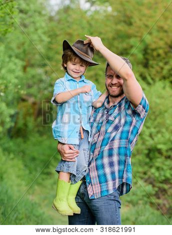 Happy Earth Day. Eco Farm. Small Boy Child Help Father In Farming. Father And Son In Cowboy Hat On R
