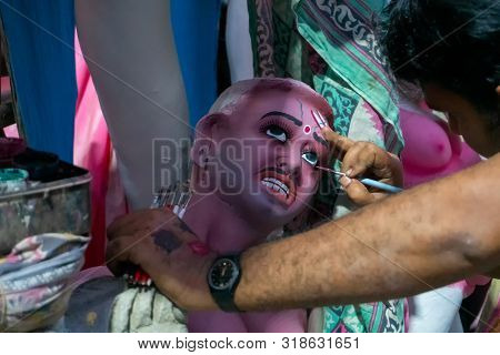 Kolkata, West Bengal, India - 7th October 2018 : Artist Painting Clay Idol Eyes Of Asura, The Demon.