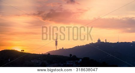 Sunset In Barcelona Overlooking The Tibidabo Mountain With The Church And The Communications Tower. 