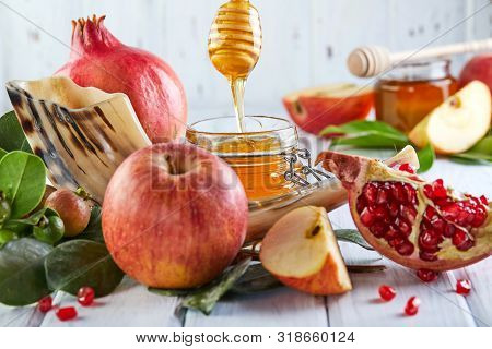 Rosh Hashanah - Jewish New Year Holiday Concept. Traditional Symbols: Honey Jar And Fresh Apples Wit