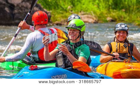 Myhiya, Ukraine - August 17, 2019: Playboating. A Company Of Young Freestyle Kayakers. A Short Break