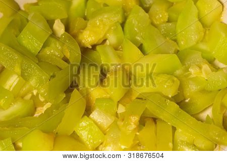 Chopped quash and bell pepper dish in white bowl. Close-up.