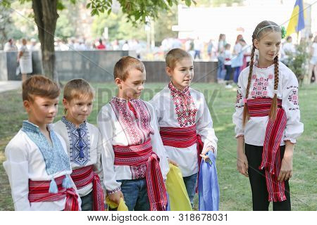 Ukraine, Pokrov - August 23, 2019: National Flag Day Celebration. Four Boys And A Girl Dressed In Fo