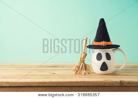 Halloween Holiday Concept With Coffee Cup And Witch Hat Decor On Wooden Table